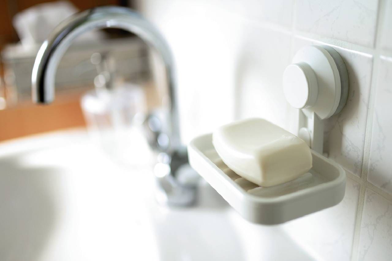 A soap dish with a bar of soap in it.